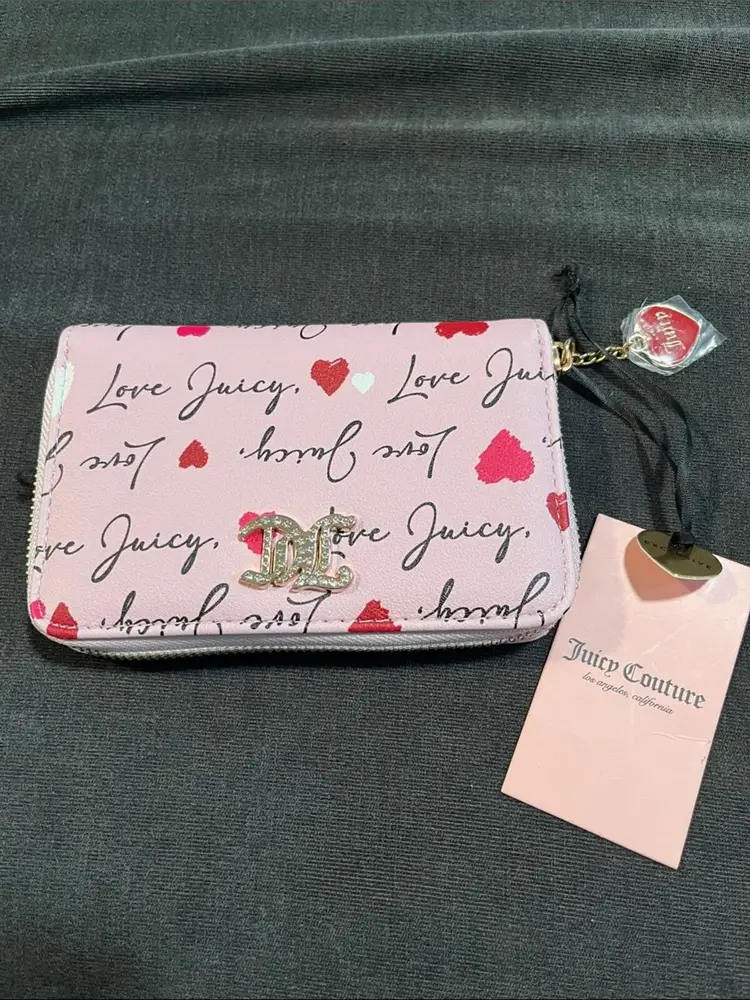 Pink Juicy Couture zip-around wallet with heart details and a gold logo charm
