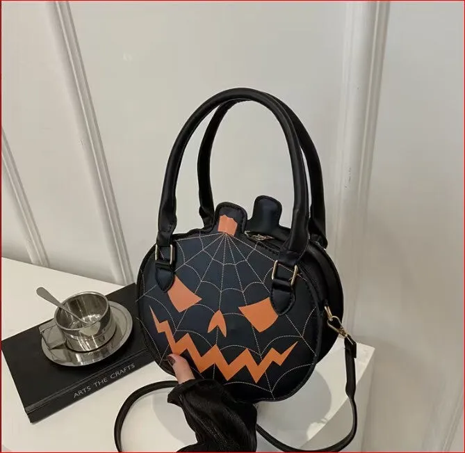 Black Halloween pumpkin face handbag with stitched spider web details